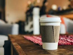 white disposable coffee cup with lid