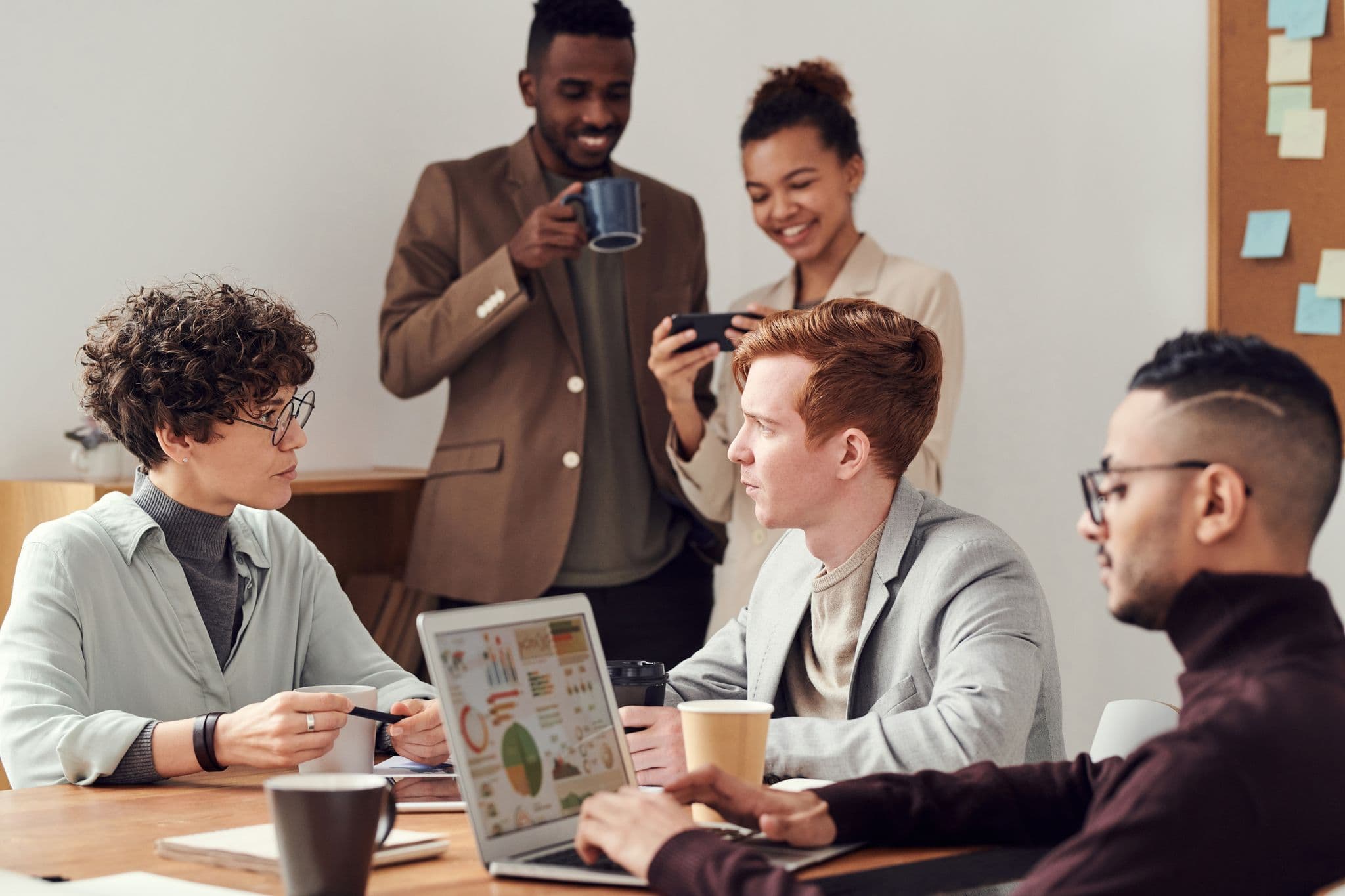 group of people in office drinking coffee and socializing